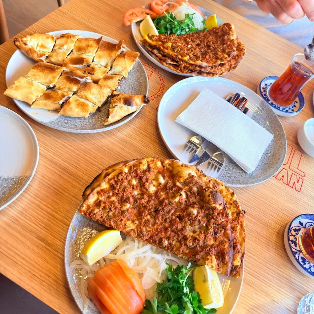 Spread of Turkish dishes including lahmacun and pide